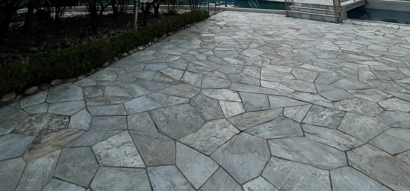 A finished flagstone patio field with tight, consistent joints running across a level surface