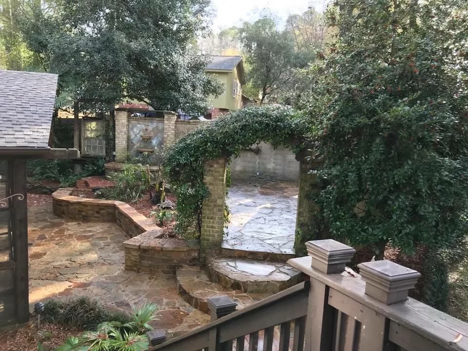 Stone patio with low stacked-stone seat walls and a step up to a second level